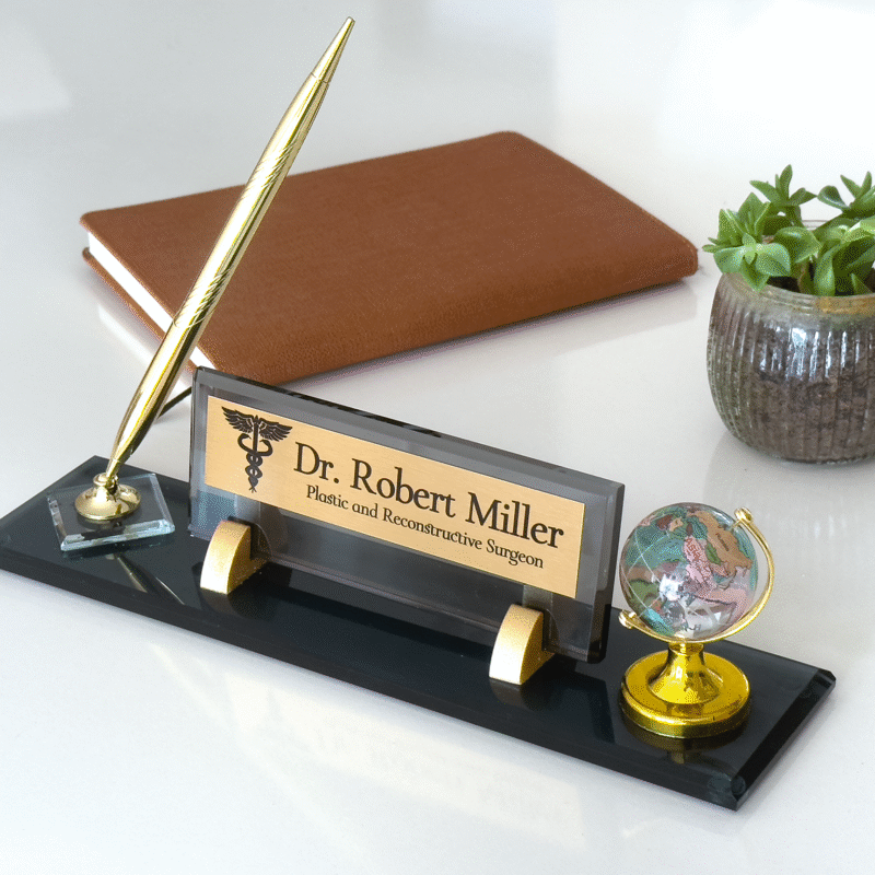 black glass desk name plate with pen and globe