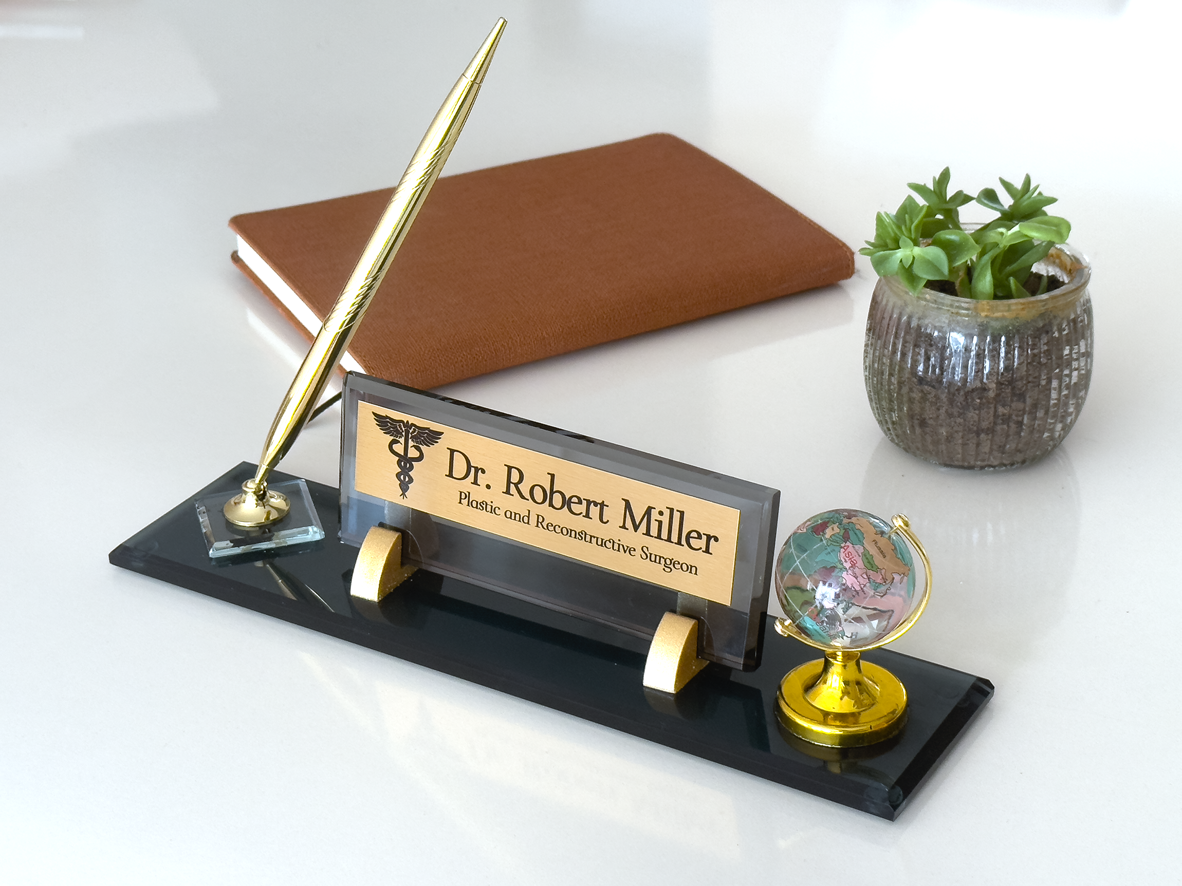black glass desk name plate with pen and globe
